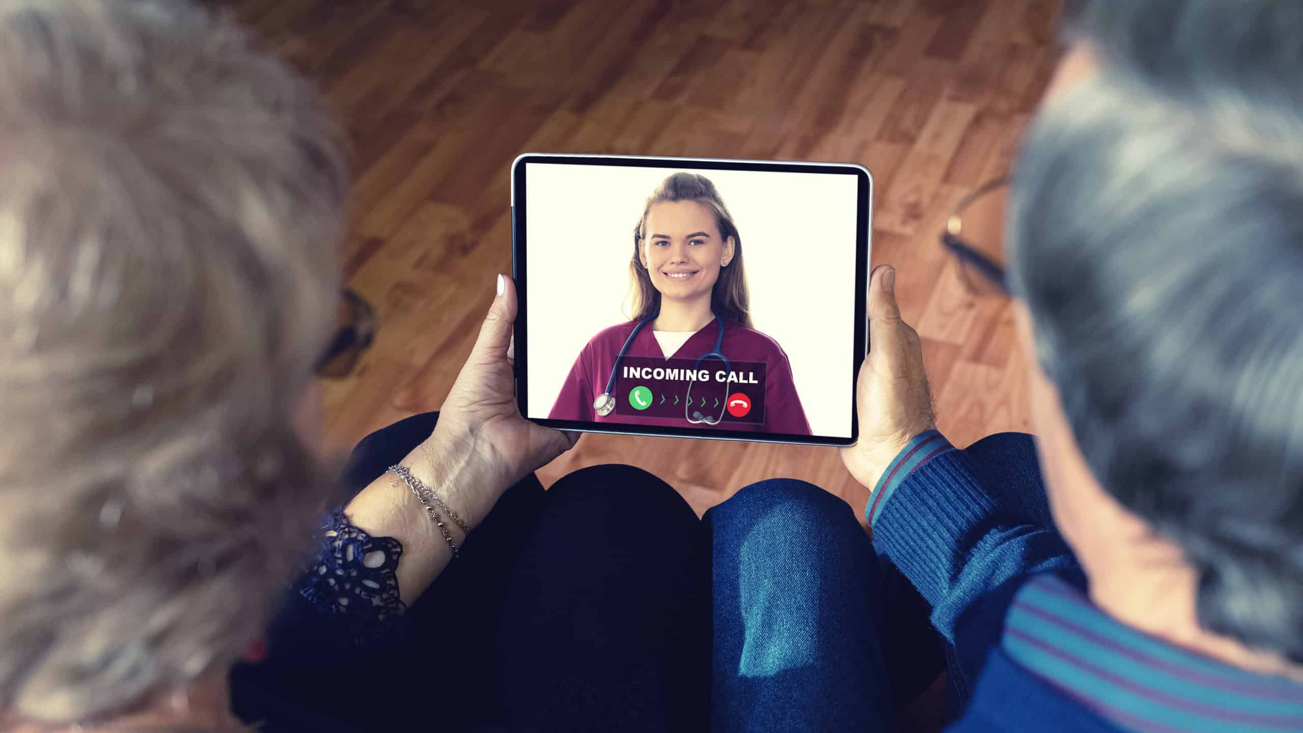 Senior Couple At Home Holding Digital Tablet During Video Call W